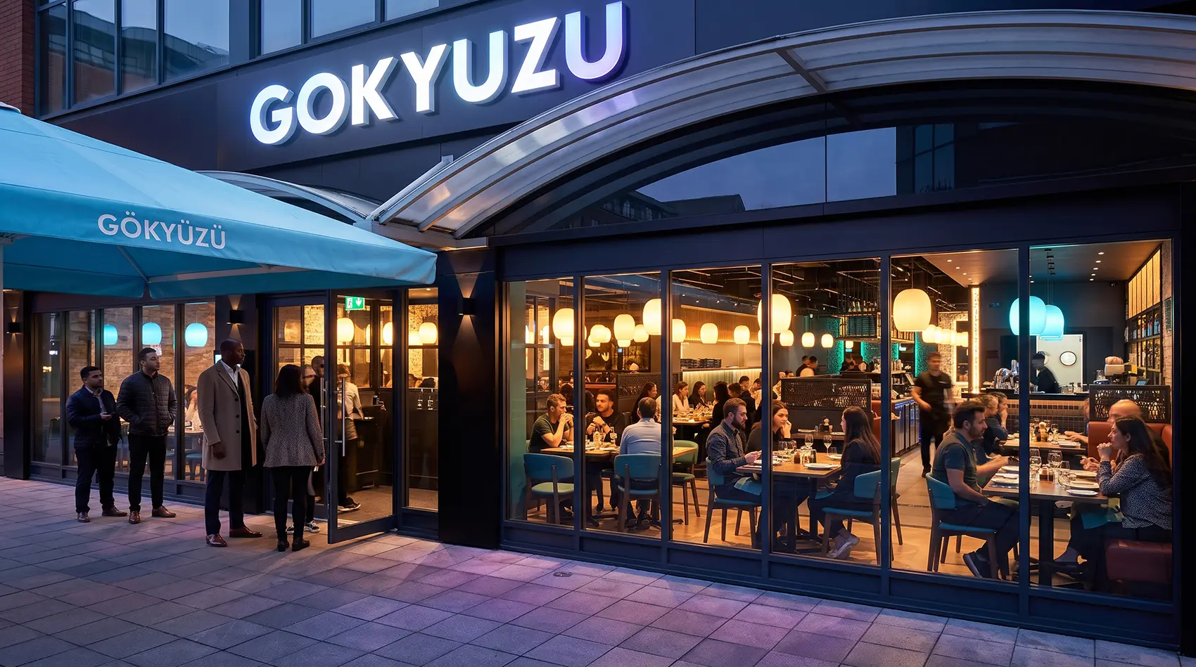 Gokyuzu restaurant storefront at night with bright signage and customers dining inside