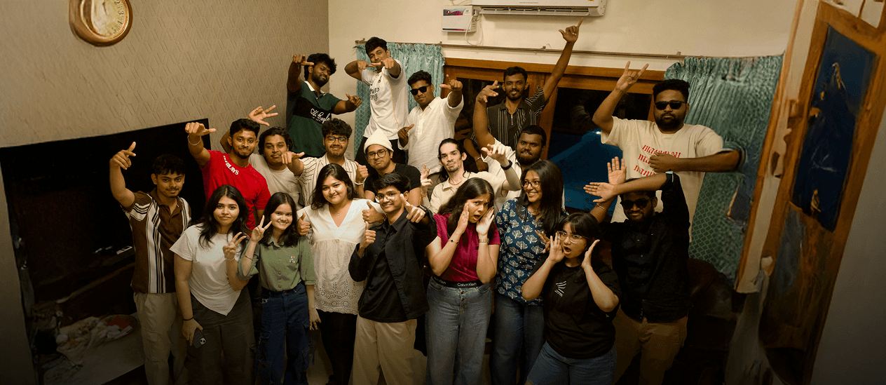 Three people sitting on a couch in a room looking at mobile devices