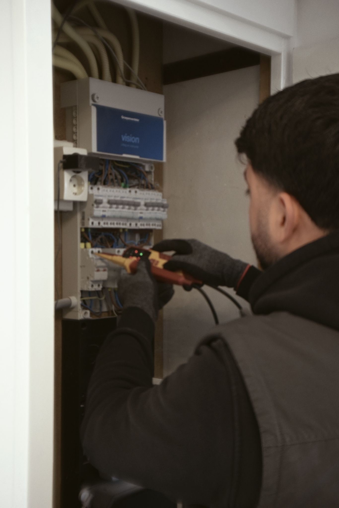 Modern glass building with illuminated facade and reflections on a rainy day at sunset