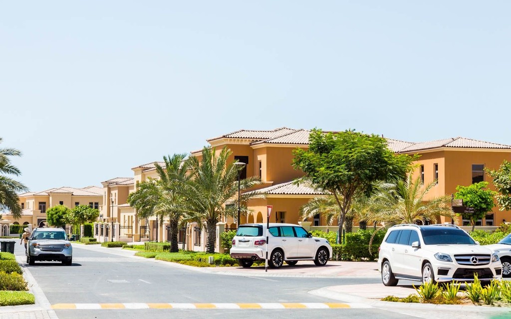 A quiet street in a residential area of Hidd Al Saadiyat, lined with houses and greenery.