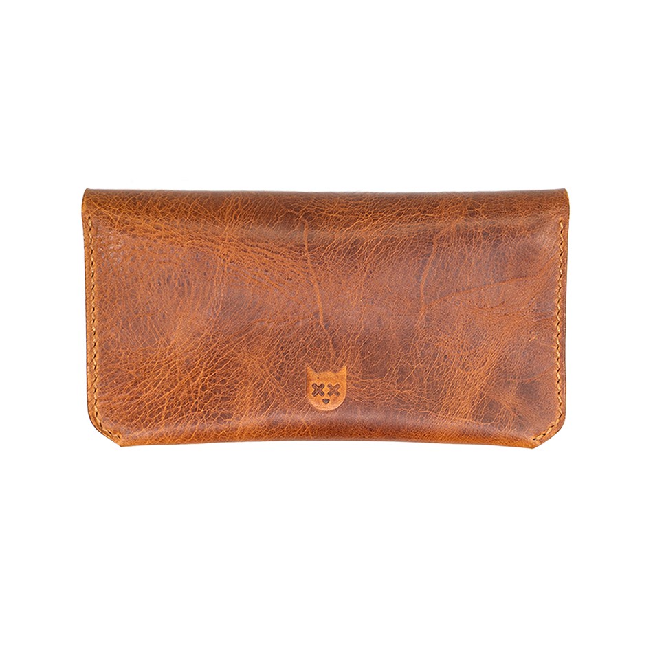 Crosstitch Leather craftsman hand-stitching a wallet in workshop