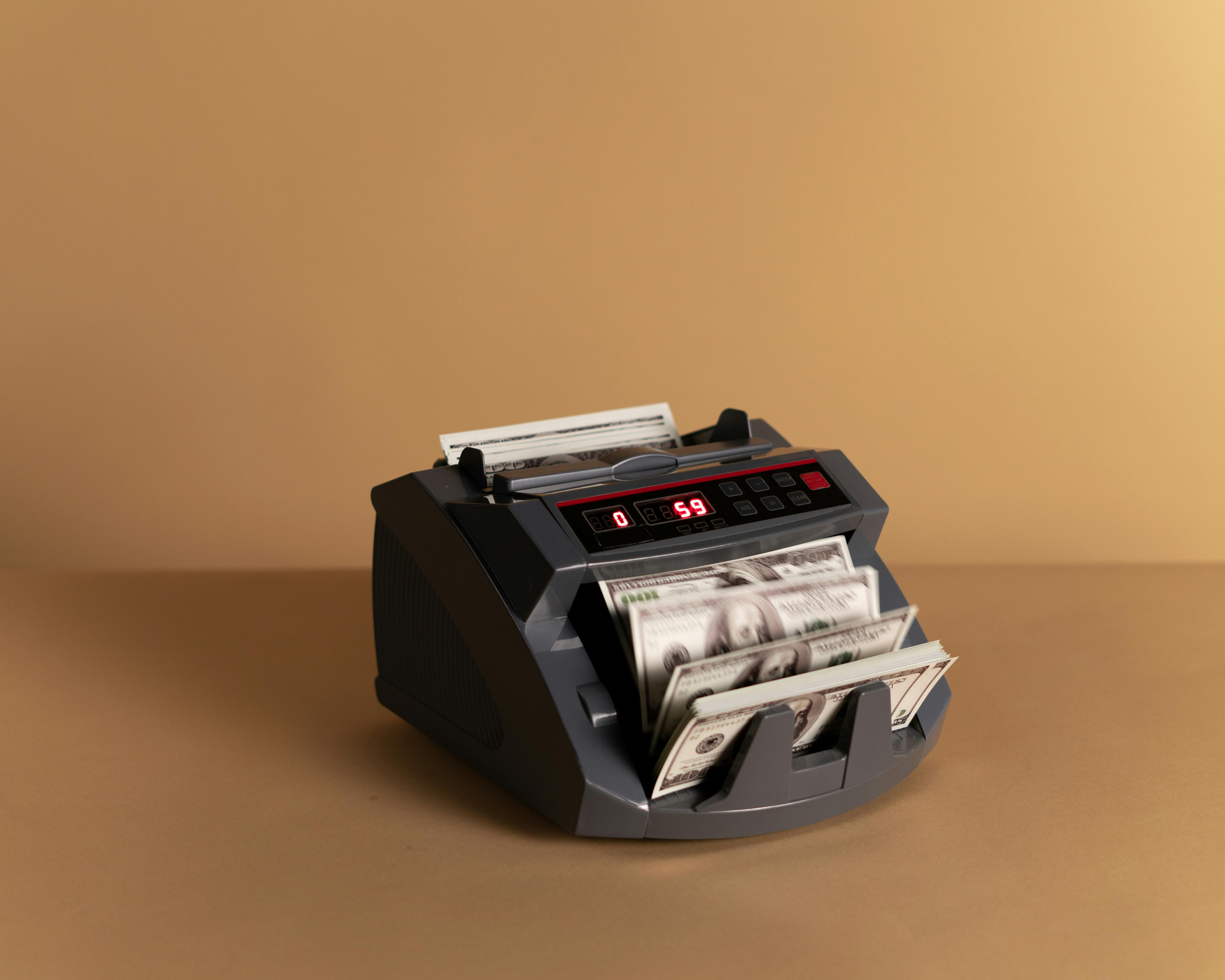 Money counting machine with hundred dollar bills inside