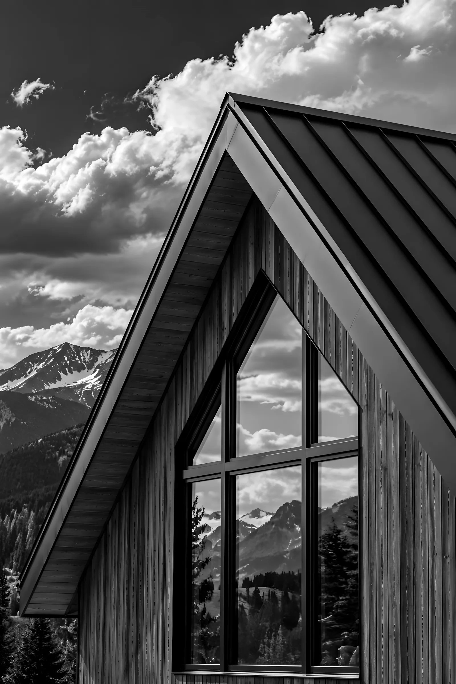 Steep standing-seam metal gable roof against dramatic clouds