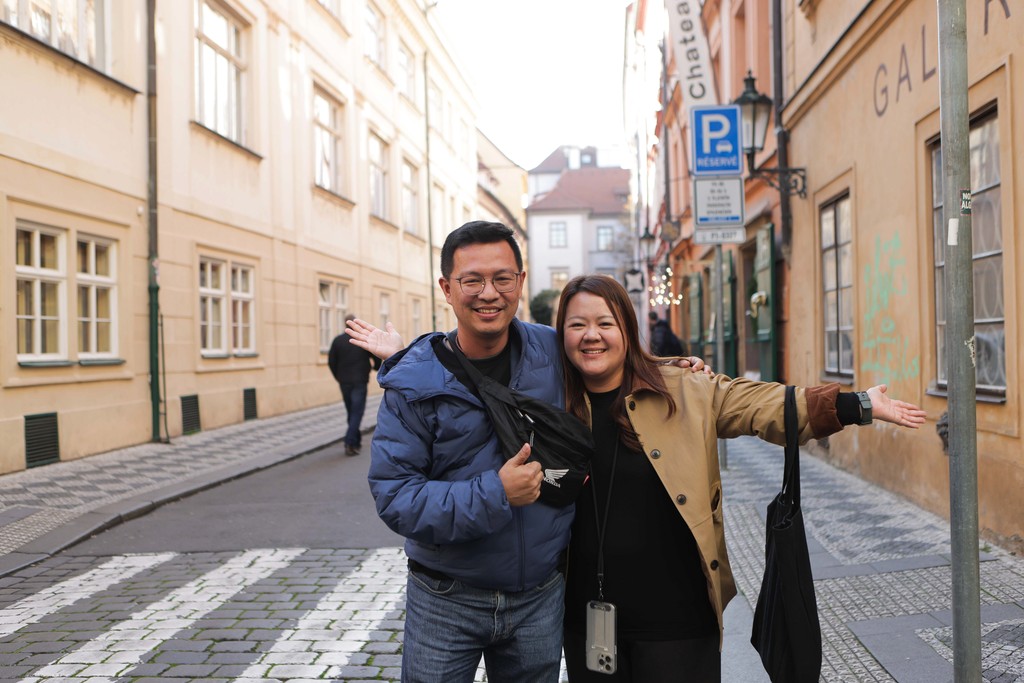 Two travellers walking together along a historic street
