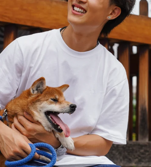 Man trimming dog nails outdoors