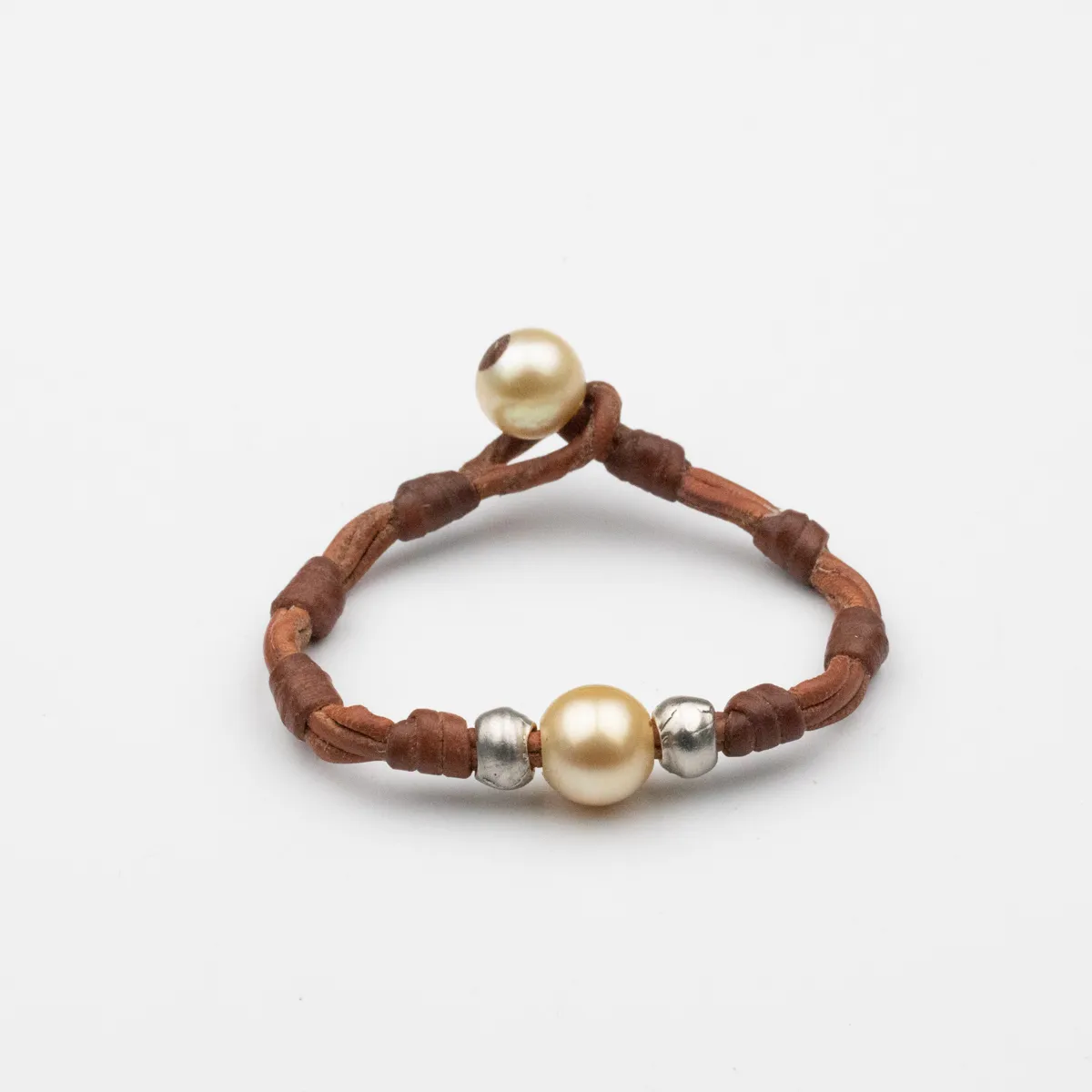South Sea Pearl and silver leather bracelet with hand-wrapped knot segments and pearl closure — Manos de Oro Saint Barth