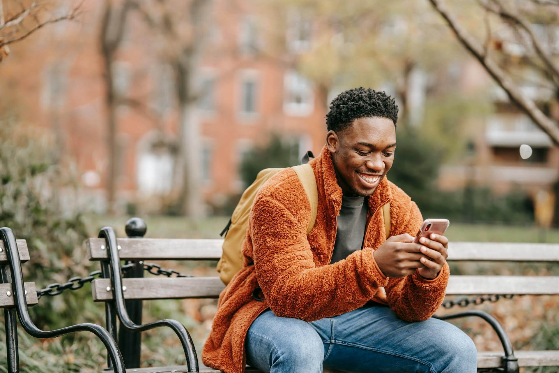 a person looking at the mobile phone and smiling