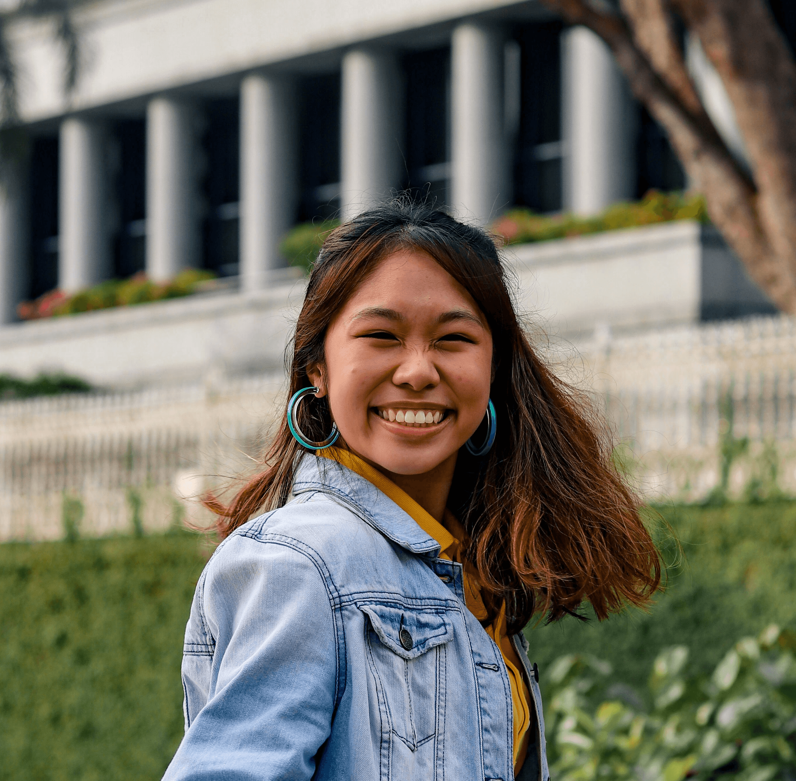 woman in blue denim jacket smiling