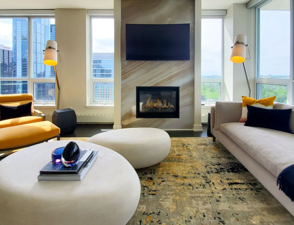 Image of Luxury living room design with fireplace, furniture, and window coverings by KHD Homes interior designers.