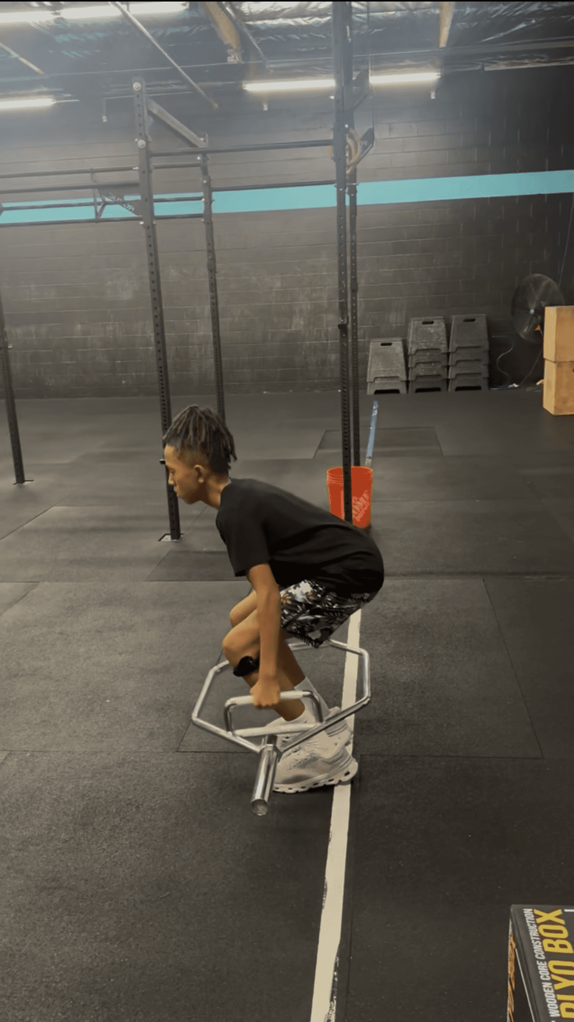 Youth soccer athlete preparing to jump with trap bar