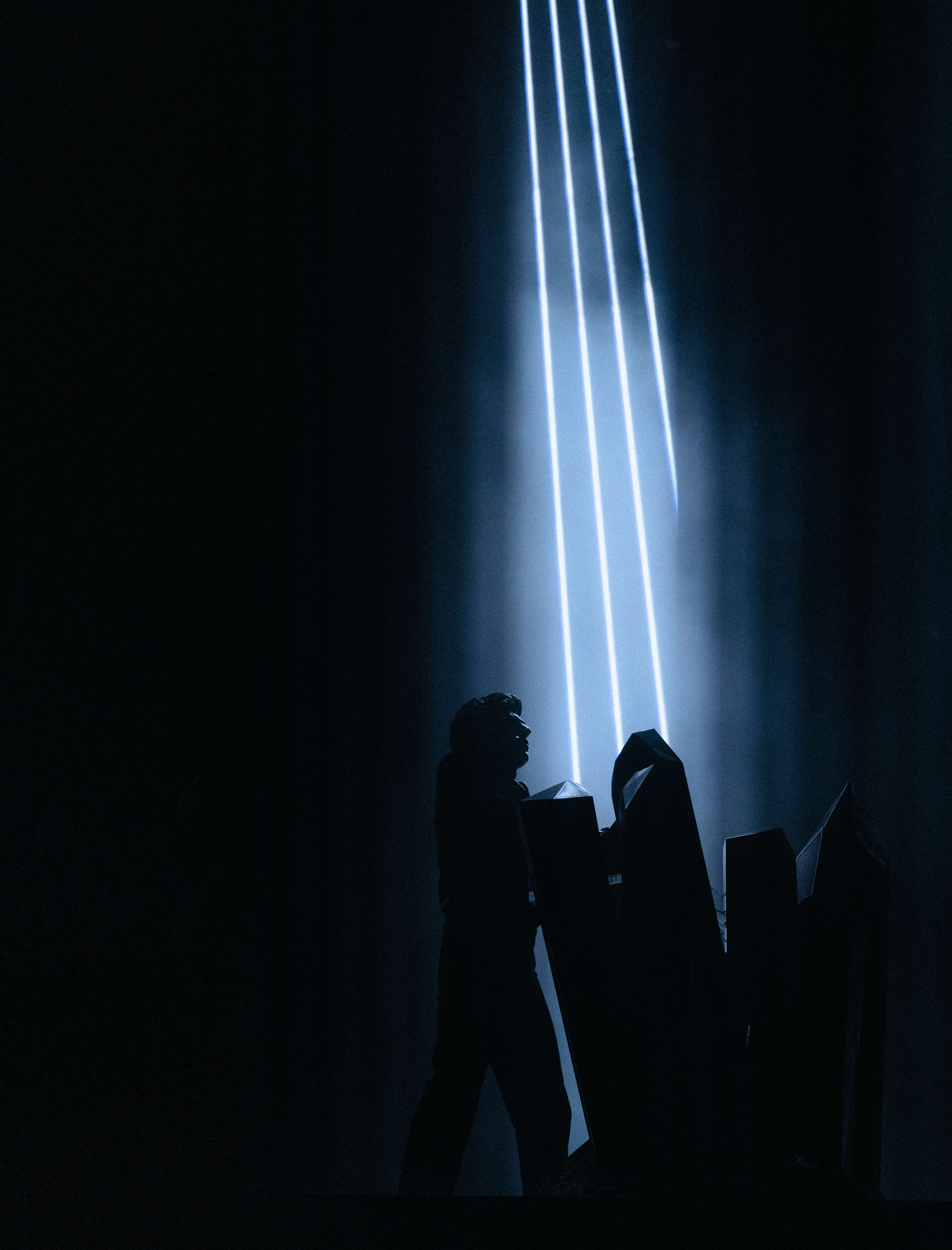 Gesaffelstein performing at Coachella 2024 in silhouette beneath vertical light beams and crystal stage structures, captured by A World Away creative director Brandon Densley