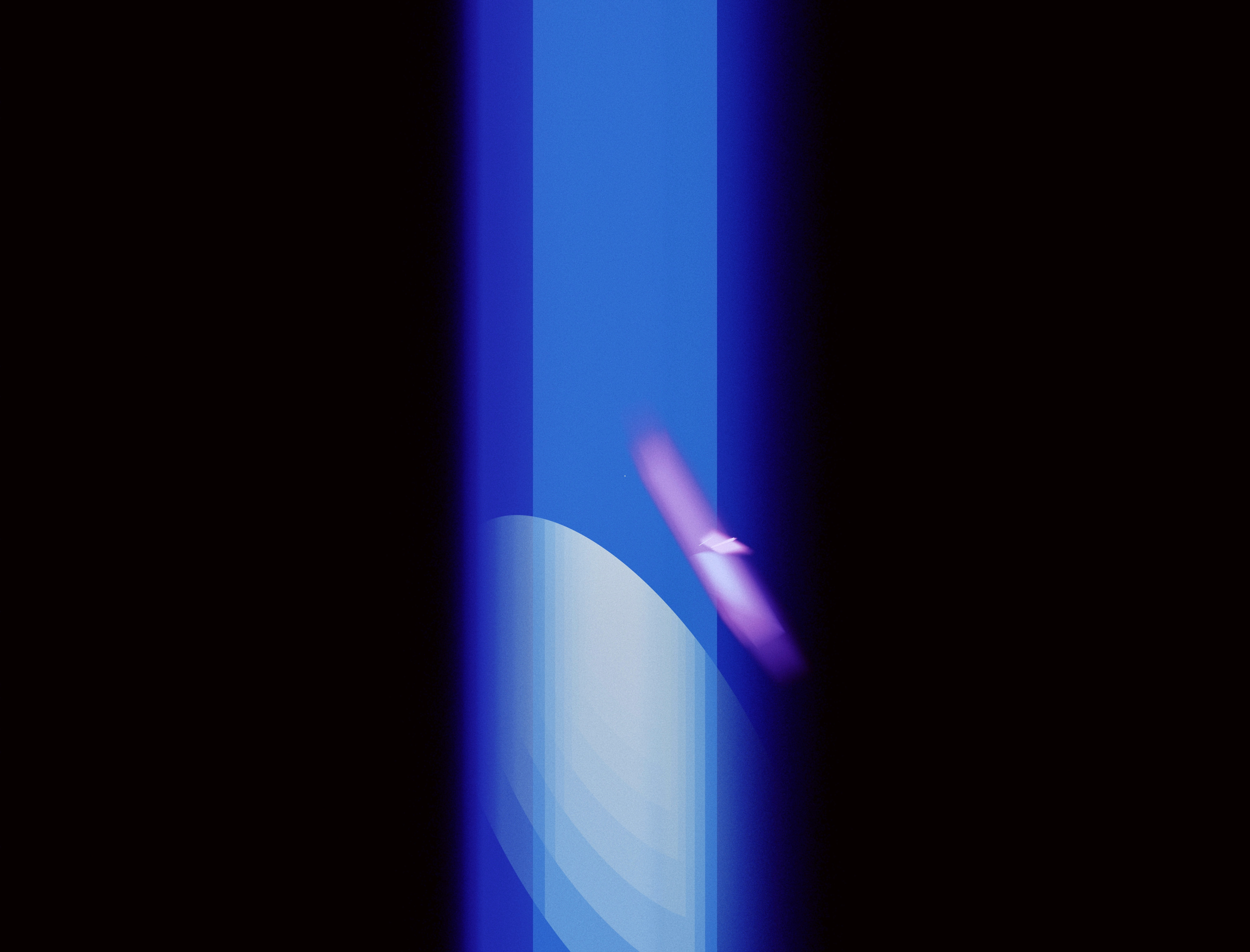 a finger pointing at a blue light