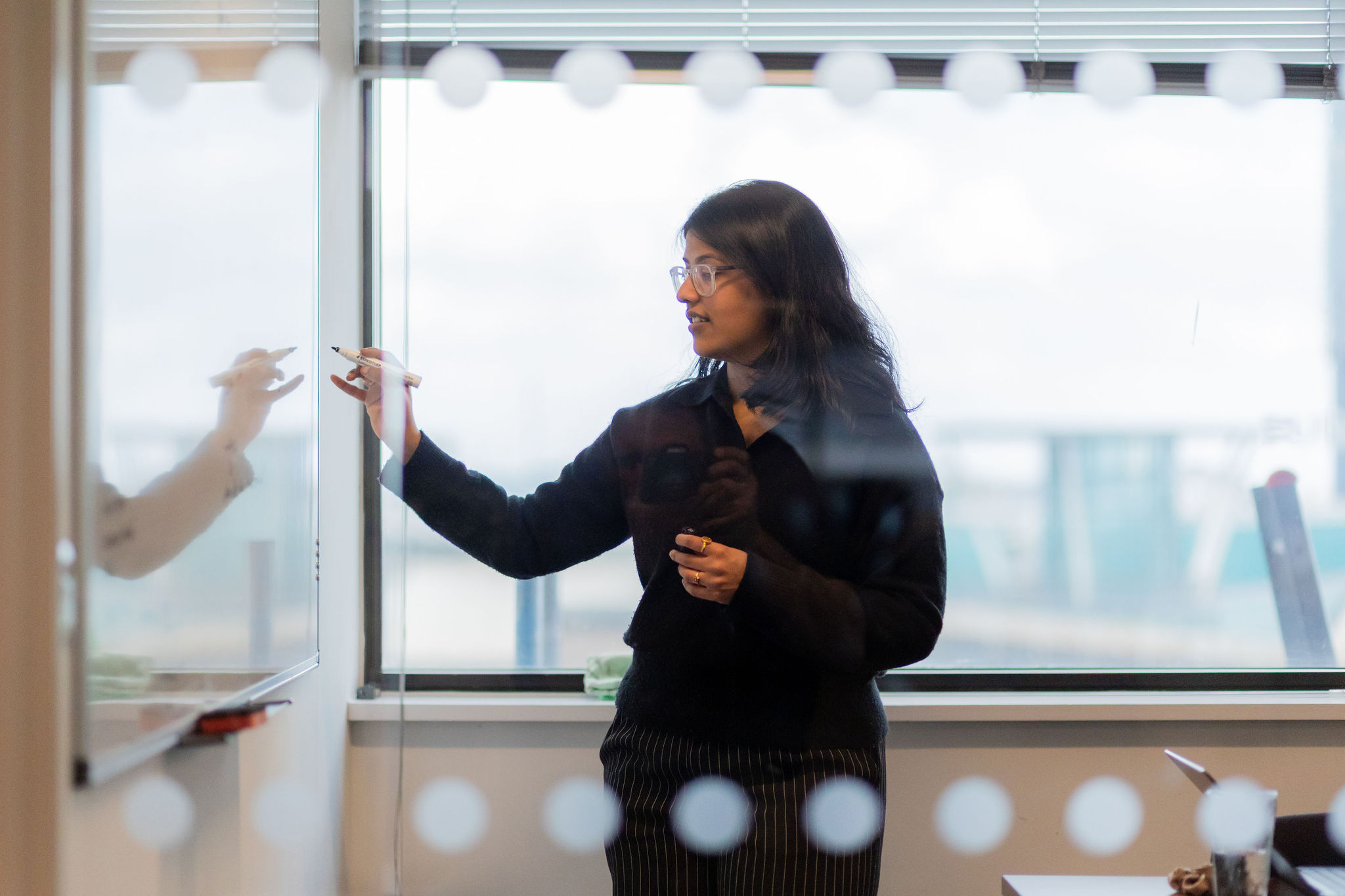 Woman holding a discovery whiteboard session