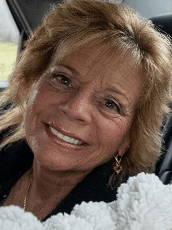 Pamela A. Petitti smiling in a close-up portrait while seated inside a vehicle.