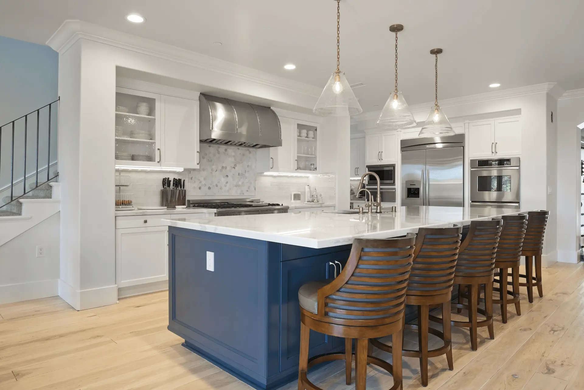 Wide perspective of the kitchen from another angle, facing the fridge, demonstrating the efficient layout and modern appliances in the Ladera Ranch Remodel. Photo by Todd Huge.
