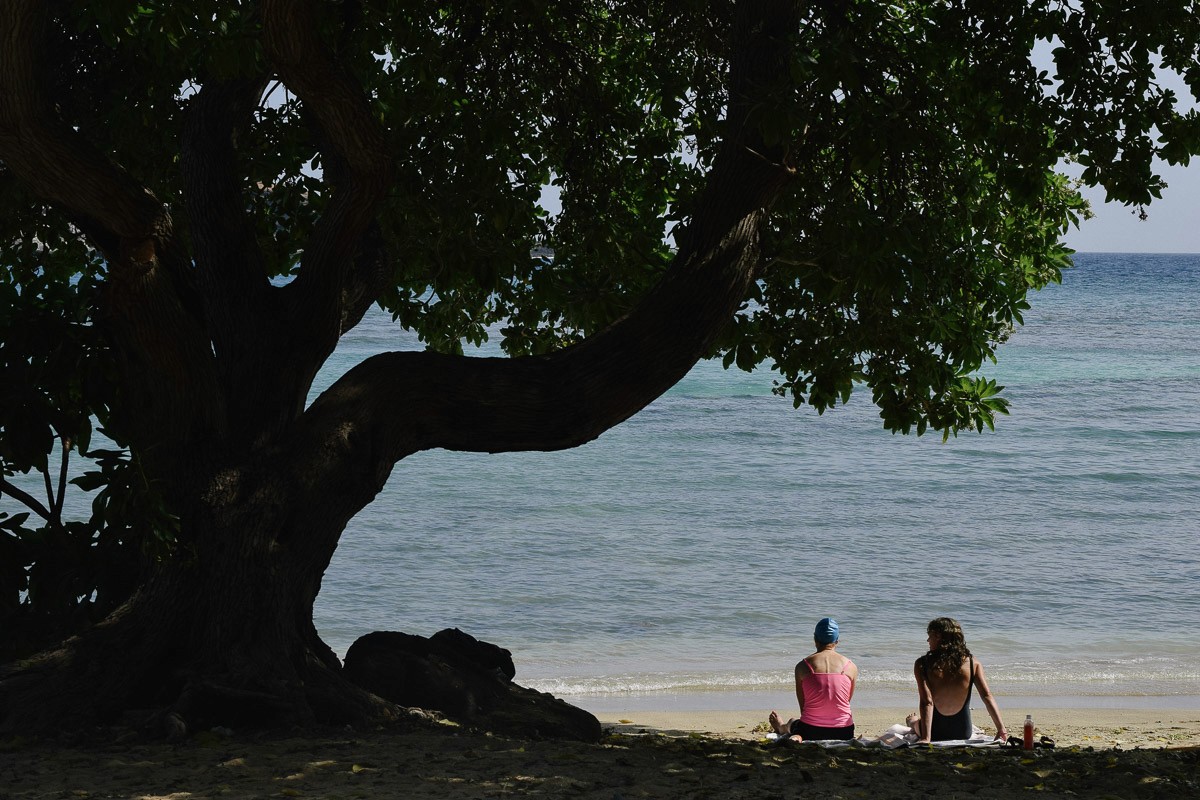 hawaii beach with two sunbathing women