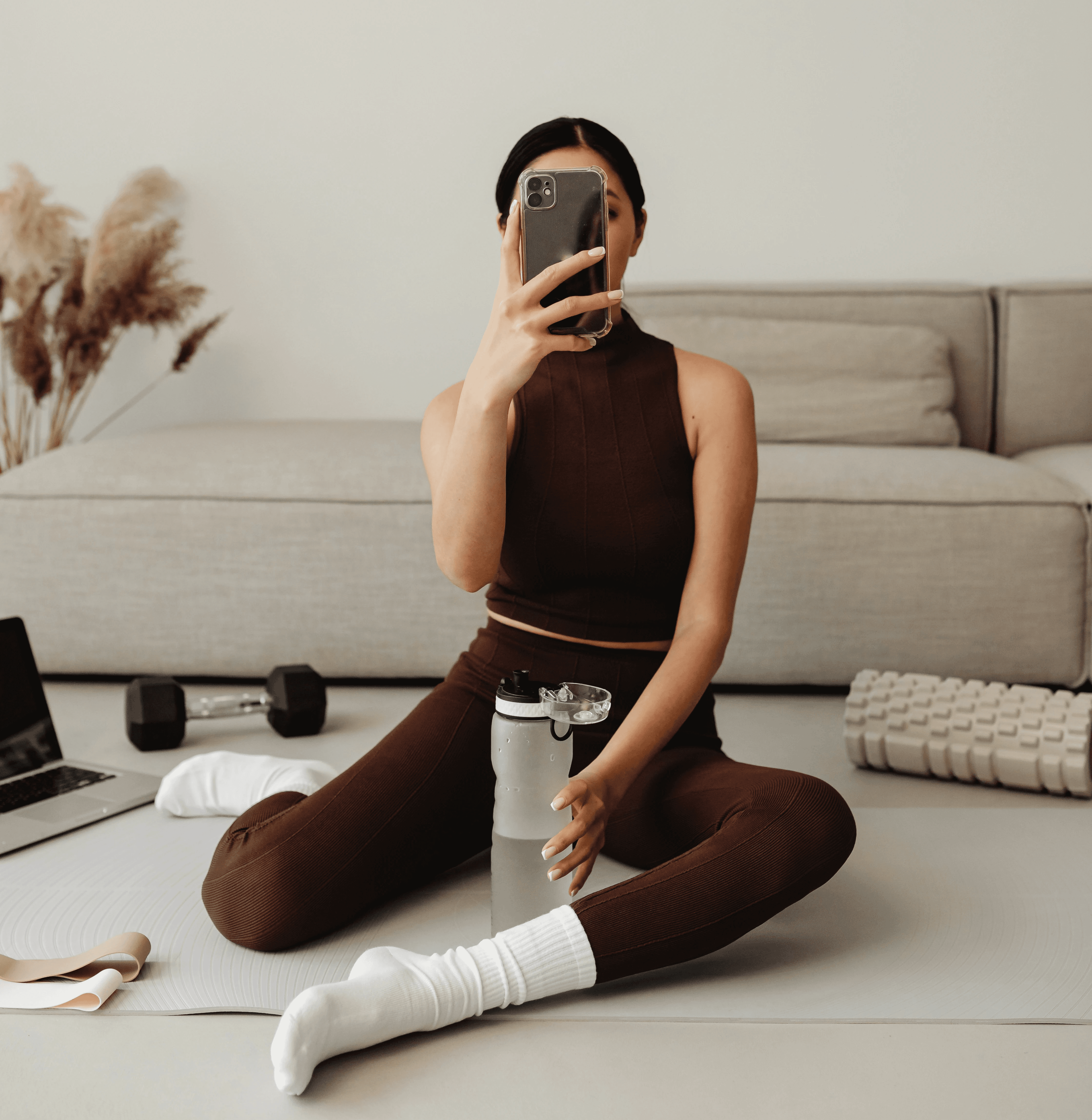 Creator filming content at home while holding a water bottle