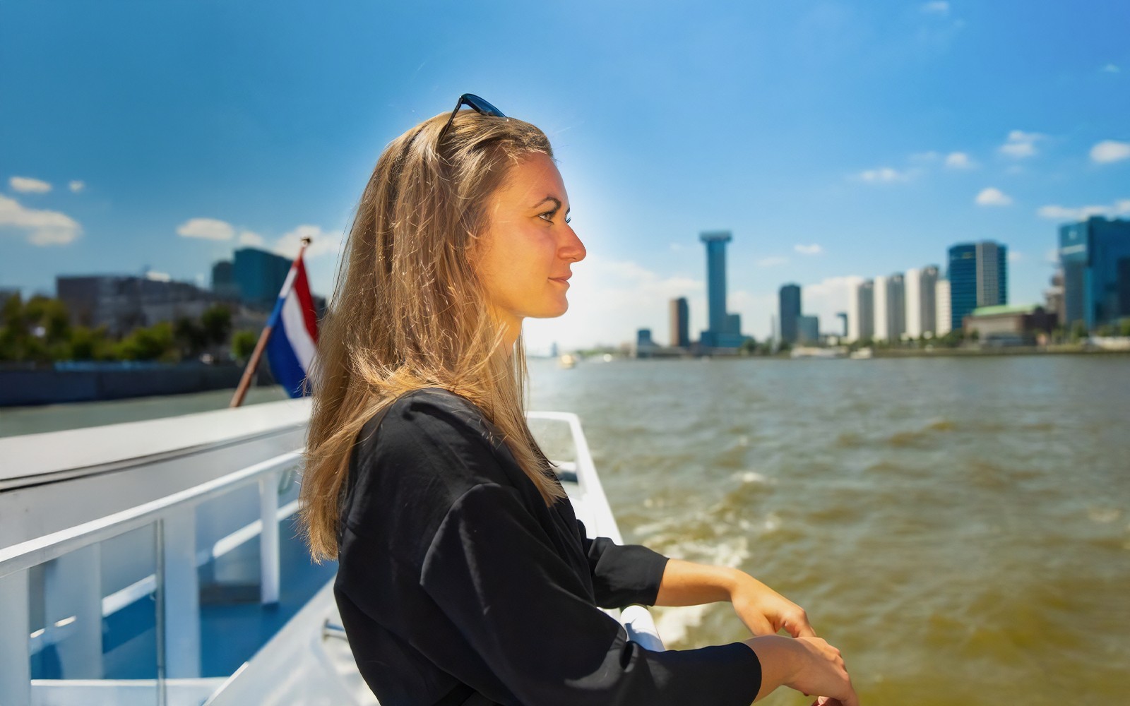 Guests enjoying the Rotterdam Harbour Cruise on a historic ship with city skyline views.