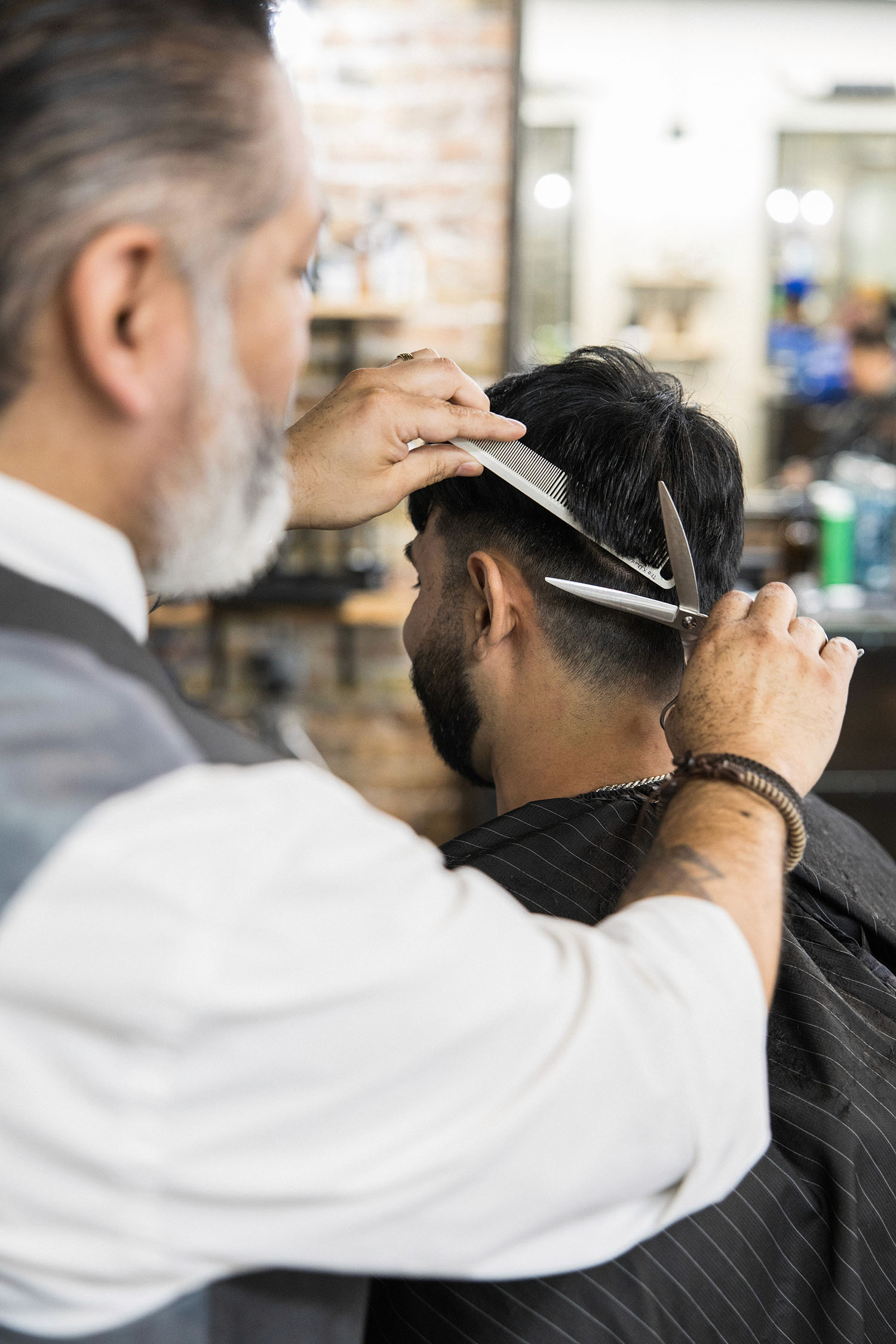 Professional haircut in progress at Old Town Barber in Chicago, highlighting skilled craftsmanship and attention to detail during the grooming process.