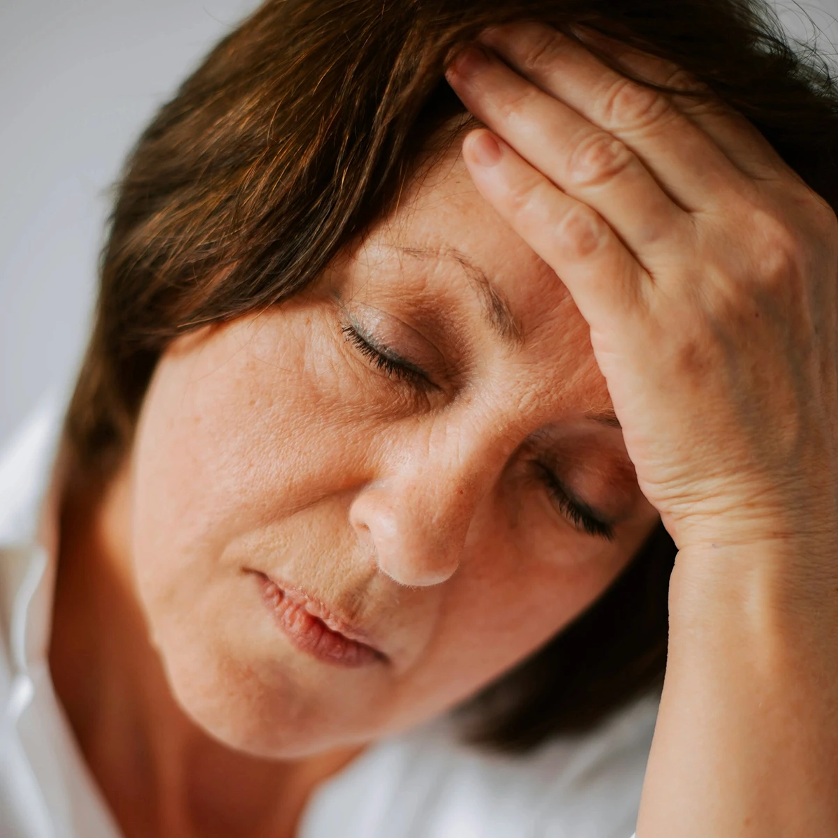 Tired woman resting her head in her hand