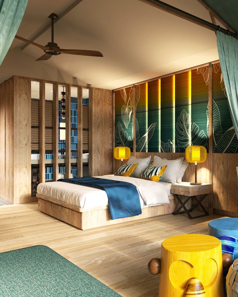 A modern bedroom featuring wooden interiors, a king-sized bed with decorative pillows, a blue throw blanket, and stylish yellow lamps on the bedside tables. The room includes a vibrant wall mural with tropical designs, a ceiling fan, and wooden flooring.