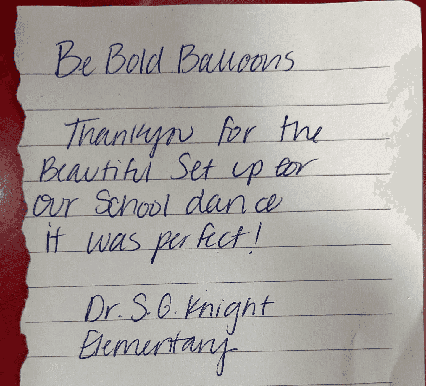 A handwritten note on lined paper expresses gratitude to "Be Bold Balloons" for the beautiful setup at a school dance, signed by Dr. S.G. Knight Elementary.