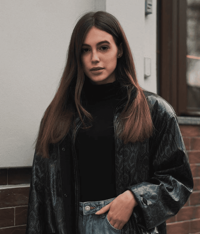 brunette woman with long hair looking direclty into the camera