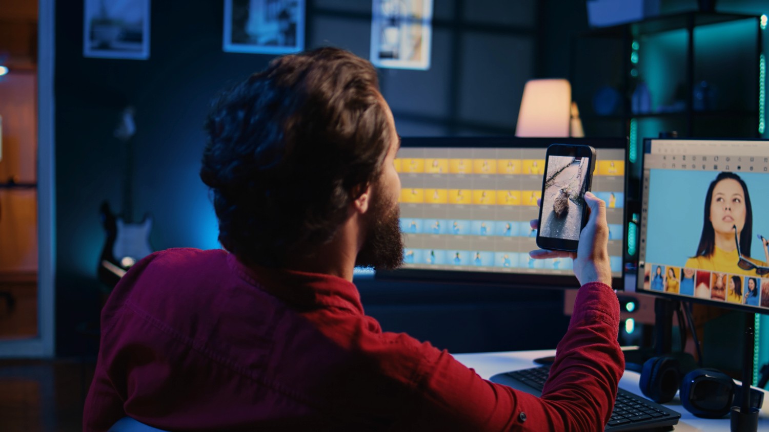  A man focused on a computer screen, creating a video with a camera set up nearby.