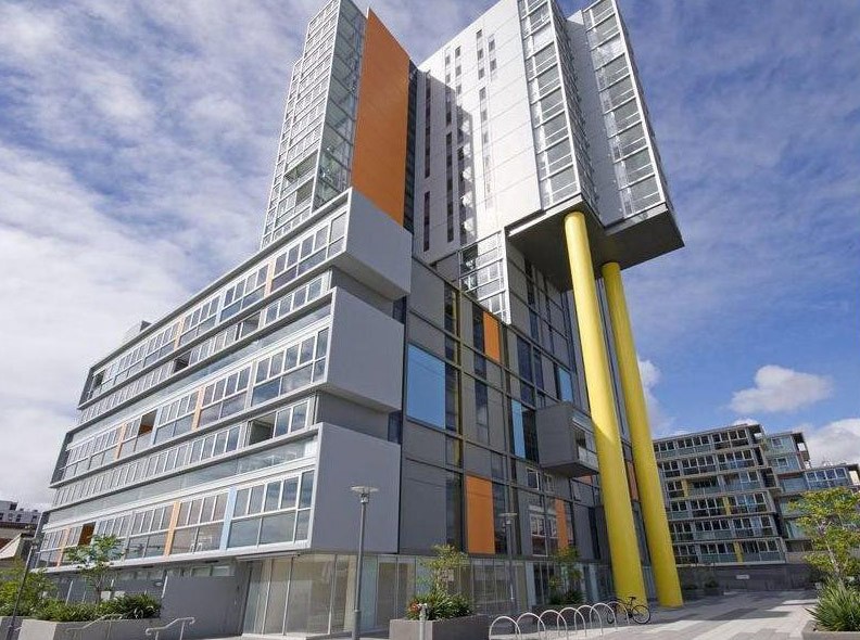 white concrete house near green tree during daytime