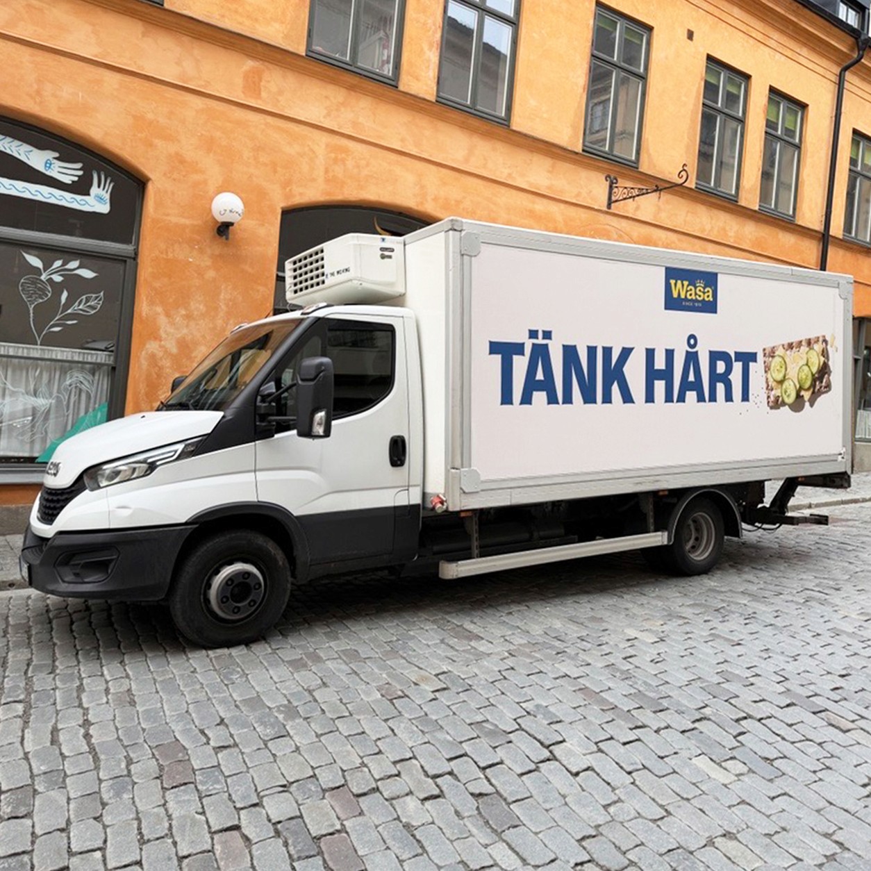 a woman holding a sign in a furniture store