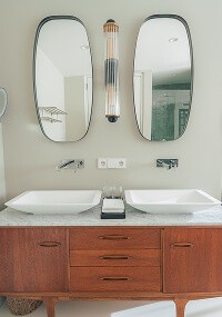man's hand pouring red wint into a glass