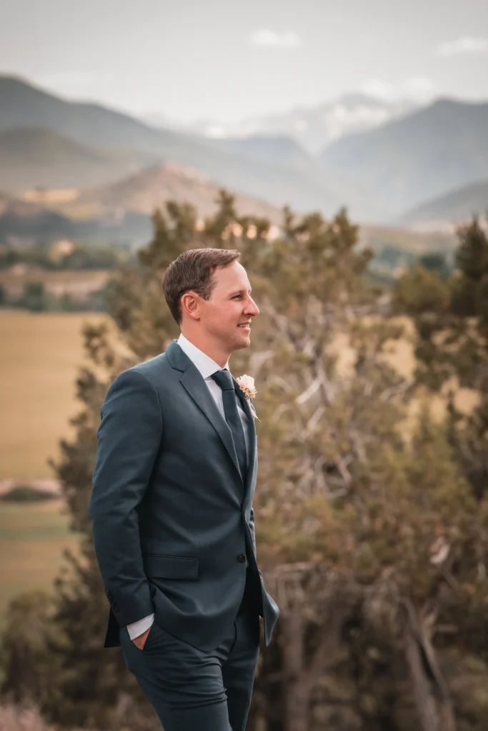 Groom portrait with blurred mountain background at Carbondale Private Ranch Wedding