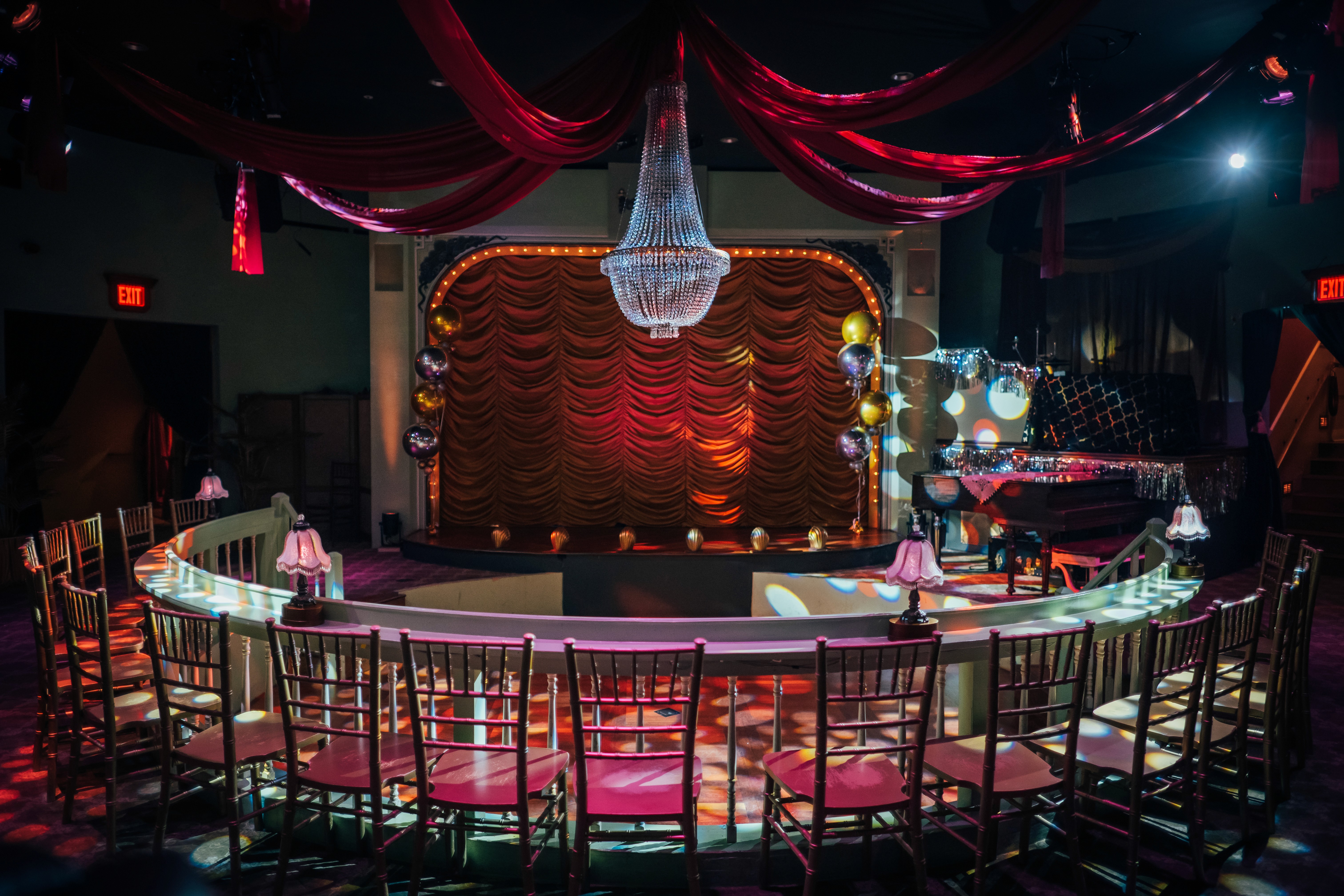 a group of people in a room with red lights