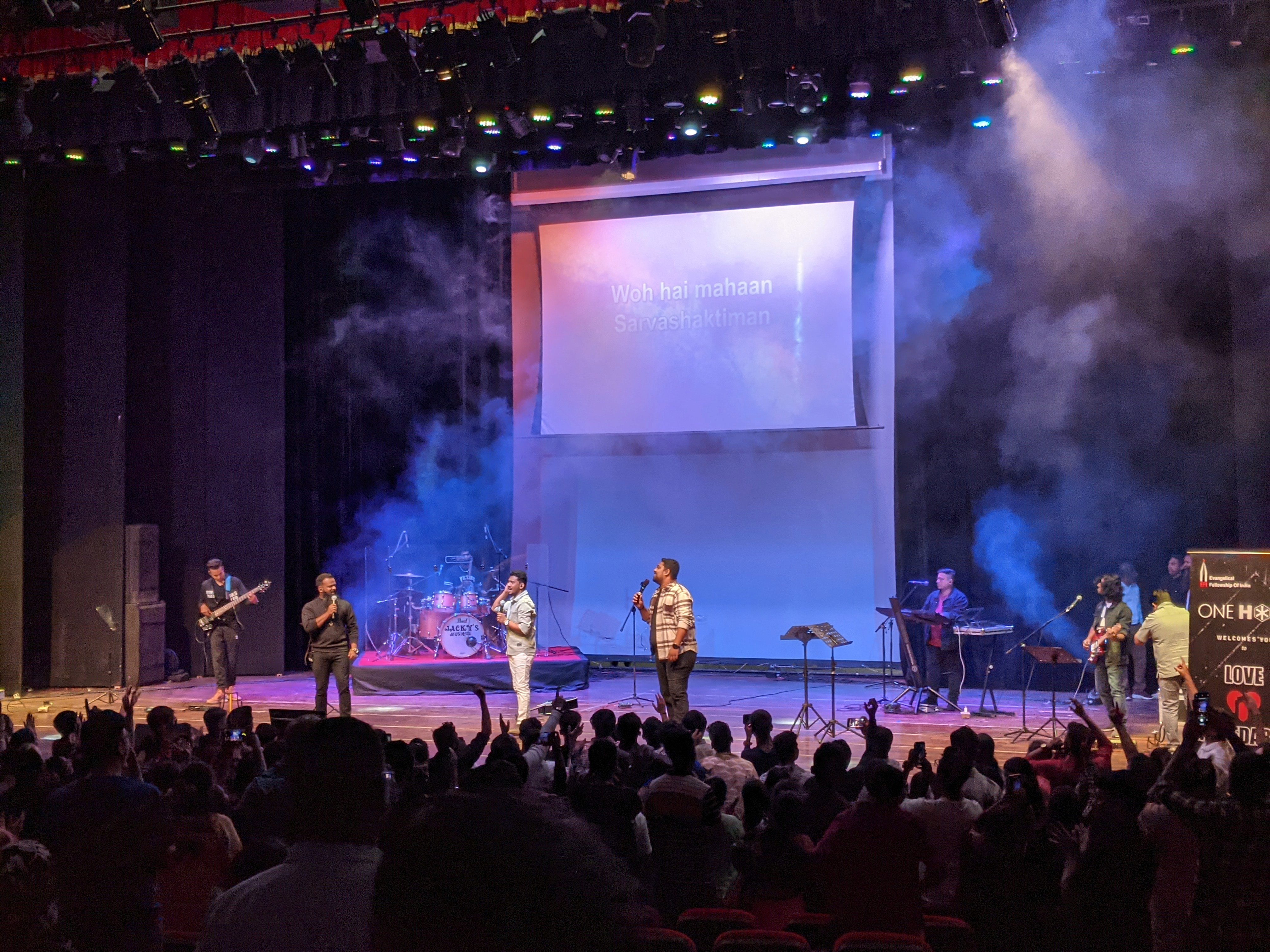 Concert photography with dramatic lighting and smoke effects, live performance atmosphere by Samuel Singh Bhakuni.