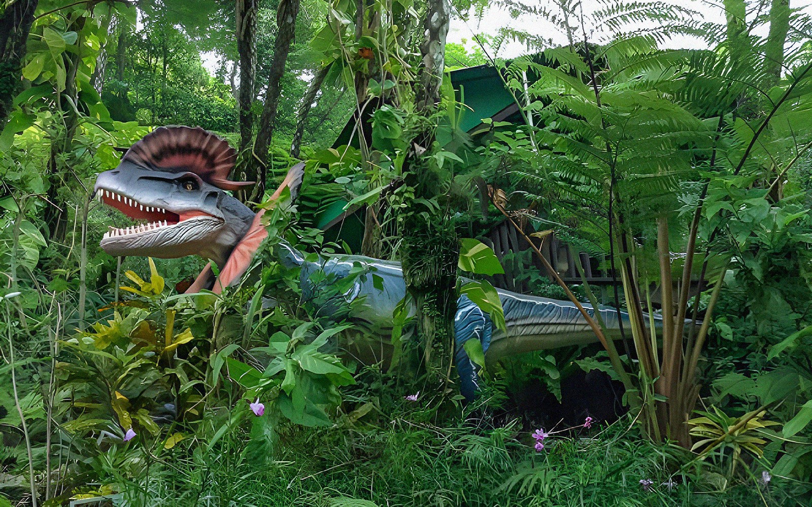 Dinosaur model in lush greenery at Dino Park Yanbaru, Okinawa.