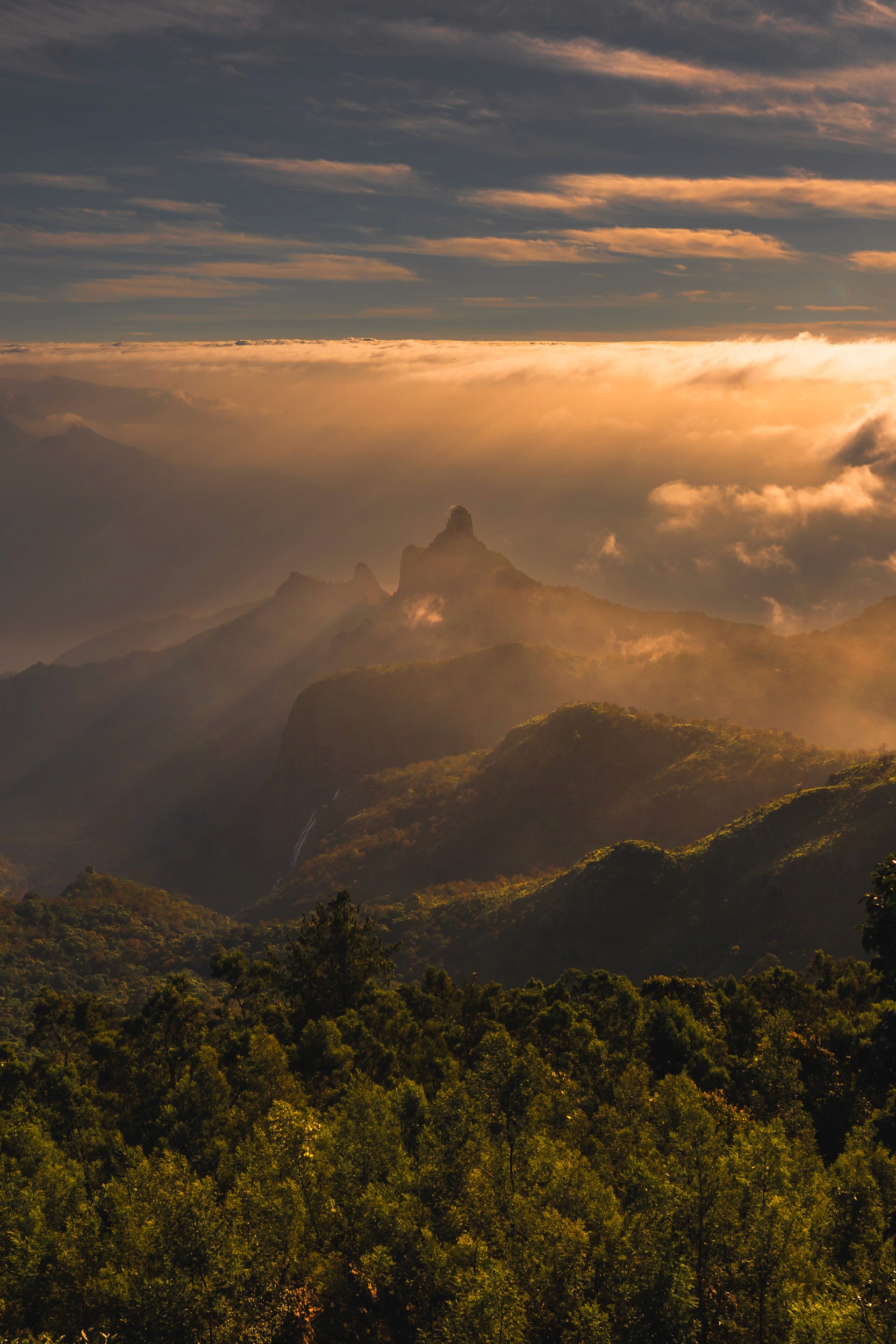 The Breath of Earth — Where the stone peak rises to meet the golden mist.