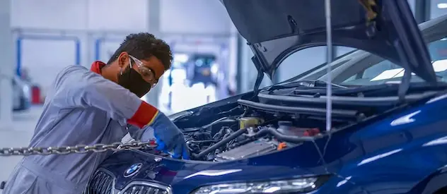Mechanic checking the marks of a car and ficing them