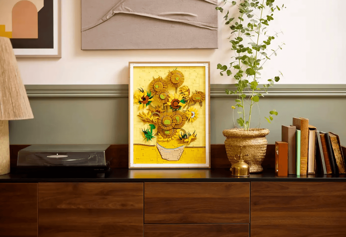 Photograph showing giveaway of Vincent van Gogh Sunflower Lego arranged in a frame with a plant and other props on the side