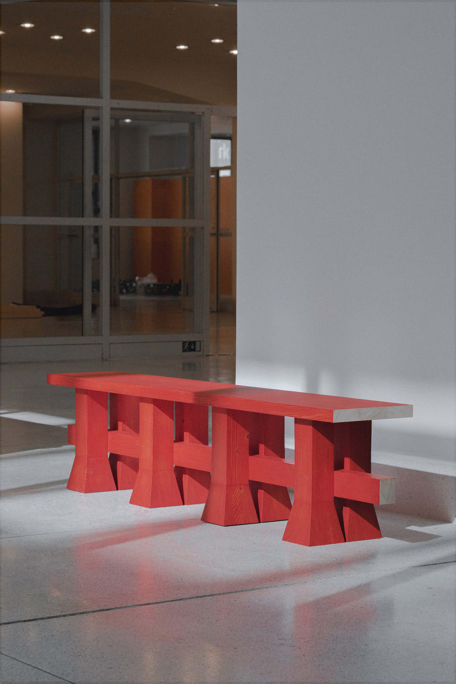 Arnaud bench in solid wood with long rectangular seat and folklore red finish by Jiri Krejcirik