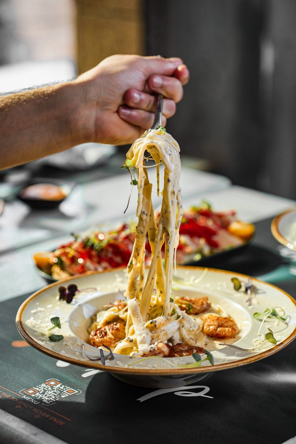 Creamy pasta with shrimp and aromatic herbs, highlighting how Dhoom blends contemporary cooking with spice stories and ingredient traditions from India.