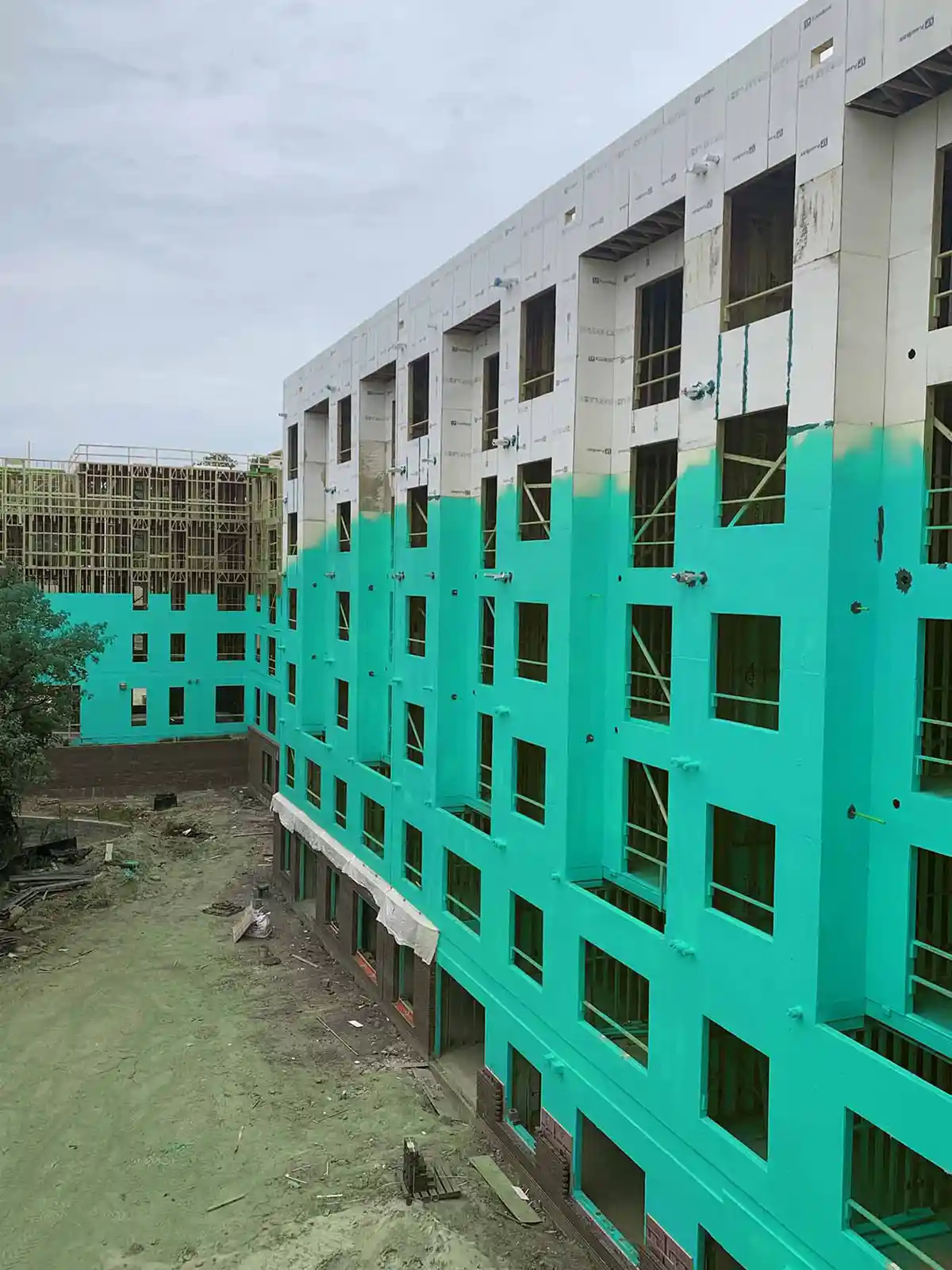 Photo of an apartment complex under construction with Rub-R-Wrap applied as an air barrier