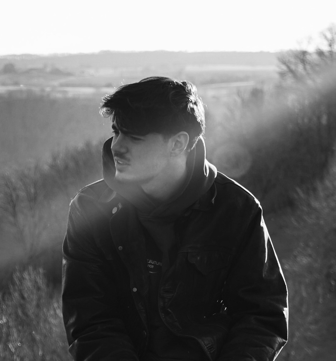 Black and white portrait of a man with a beard and glasses