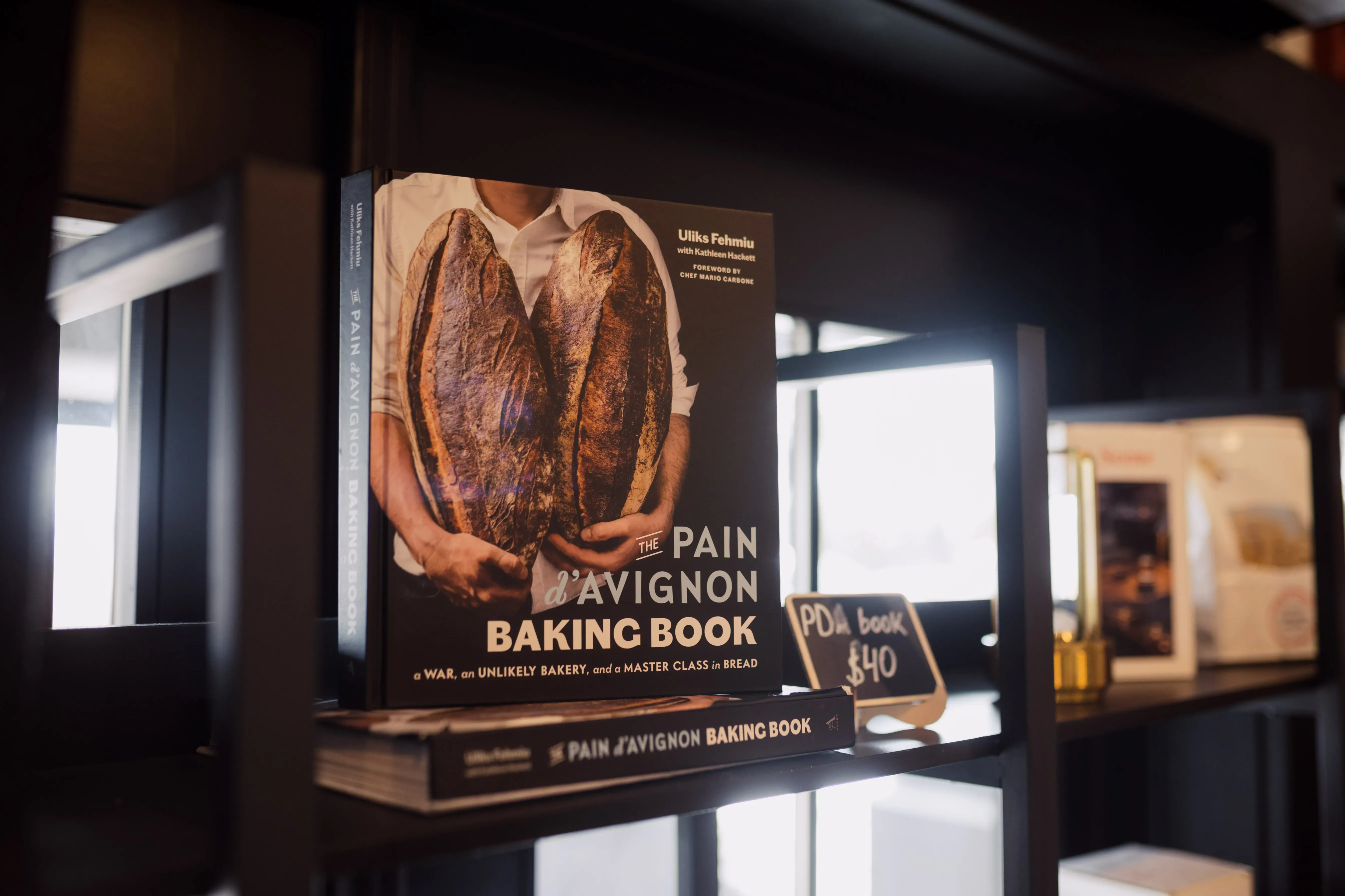 Pain d'Avignon retail display — The Pain d'Avignon Baking Book alongside branded merchandise