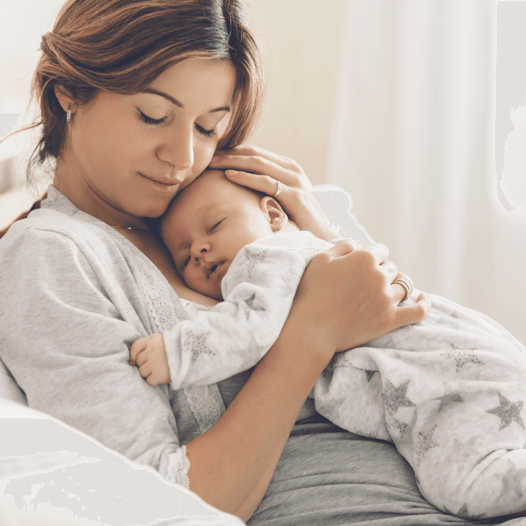 Mother holding sleeping newborn, symbolizing healthy pregnancy and family after fertility care.