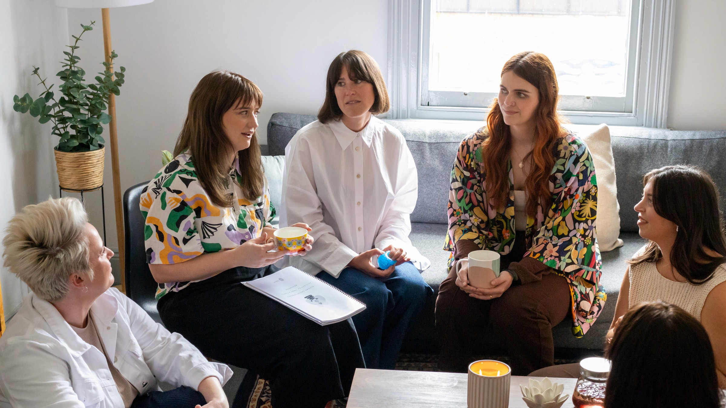 a group of people holding hands on top of a tree
