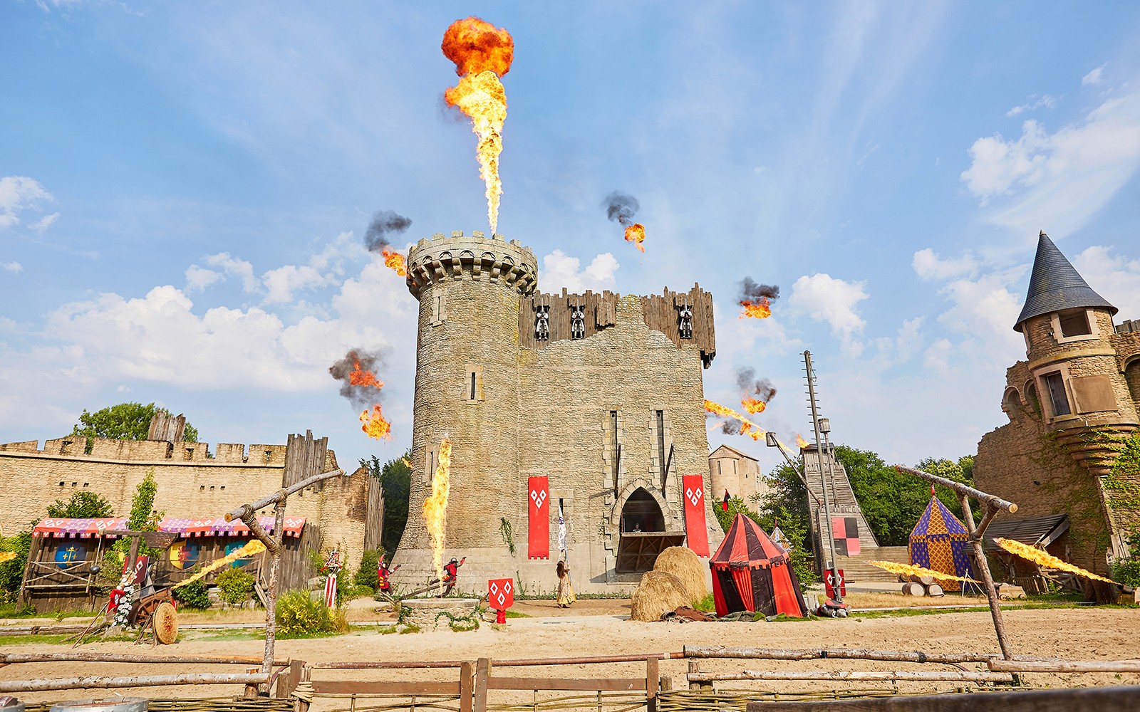 Medieval castle with fire effects at Puy du Fou Theme Park.