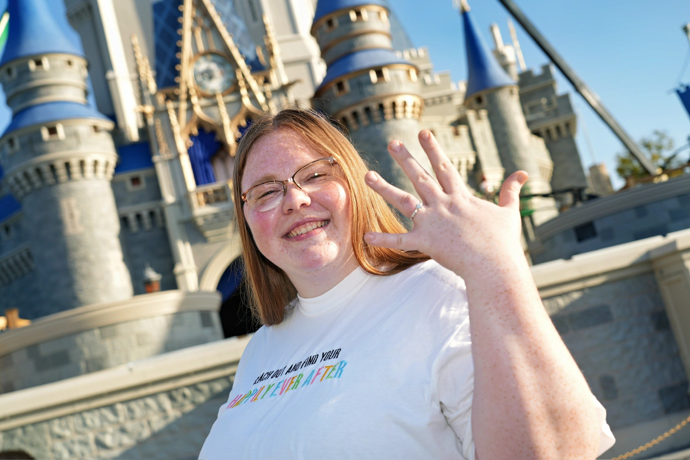person sitting on grass and using phone