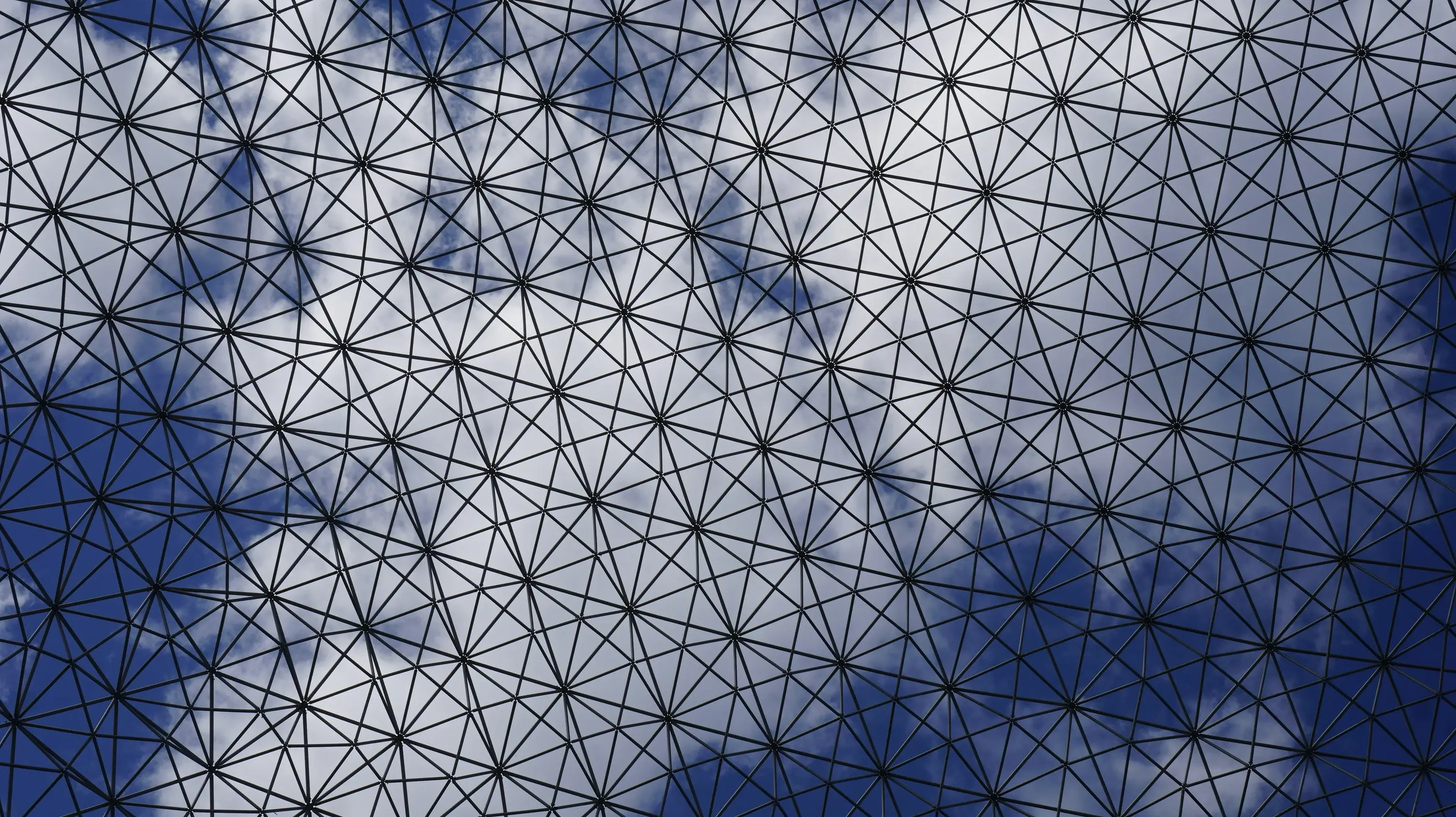 Abstract blue and white geometric network pattern with interconnected triangular lines.