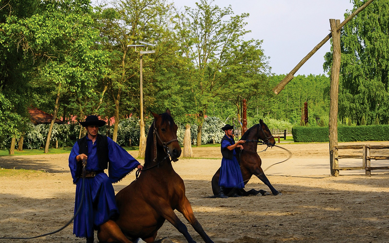 Horsemen performing in traditional attire during Puszta horse show in Kecskemet, Hungary.