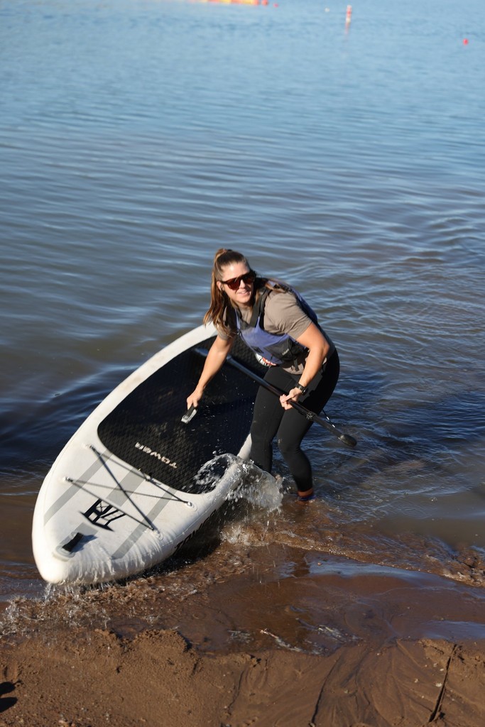 Paddleboarder launching from the shore